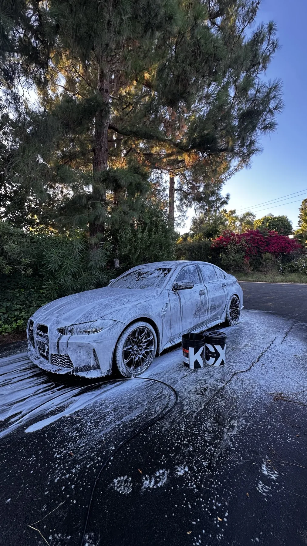 BMW covered in foam during ceramic coating preparation