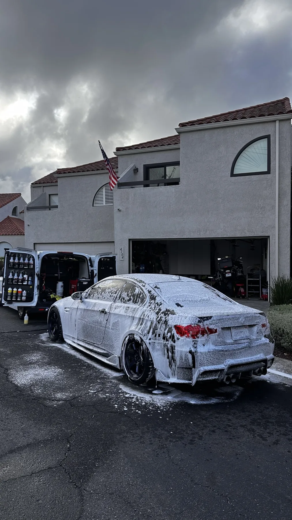 Sedan receiving a thorough foam wash before paint preparation