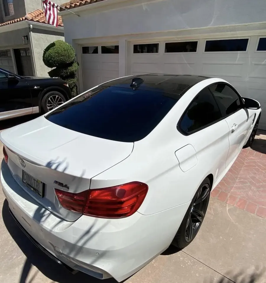 White BMW M4, rear three-quarter view
